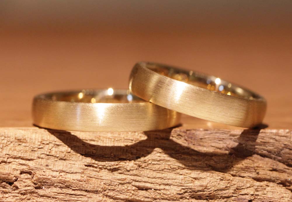 Image 037: simple wedding rings in rose gold without stones, matt outside, polished inside.