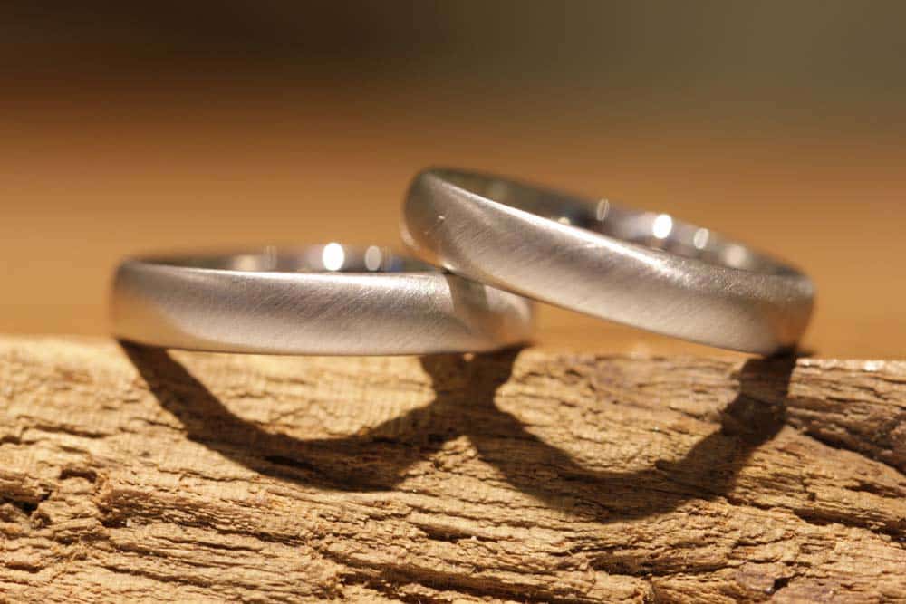 modern platinum wedding rings, satin finish, hand-forged
