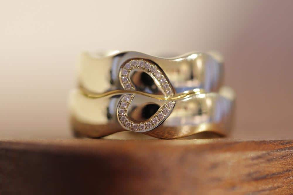 Image 158: Wave rings made of white gold with a split heart made of diamonds.