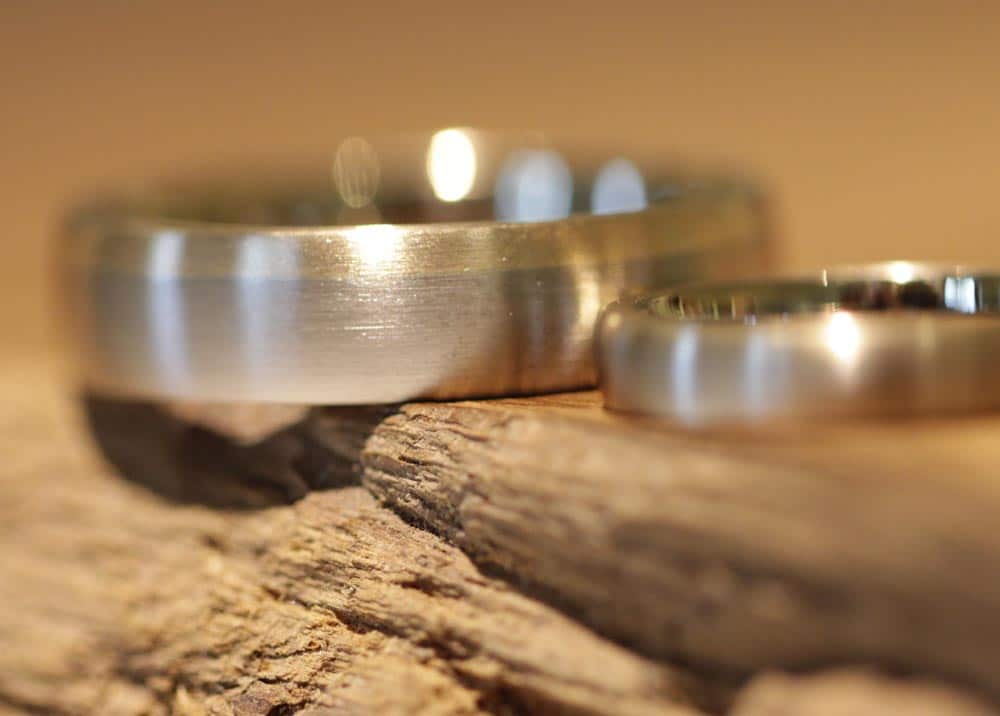 Image 164: two-tone wedding rings made of gray and rose gold, matt surface.
