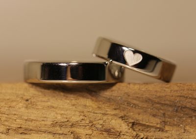 Platinum wedding rings with heart engraving on the outside