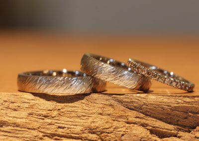 Forged gold wedding rings with matching ring set with brown diamonds in a crown setting