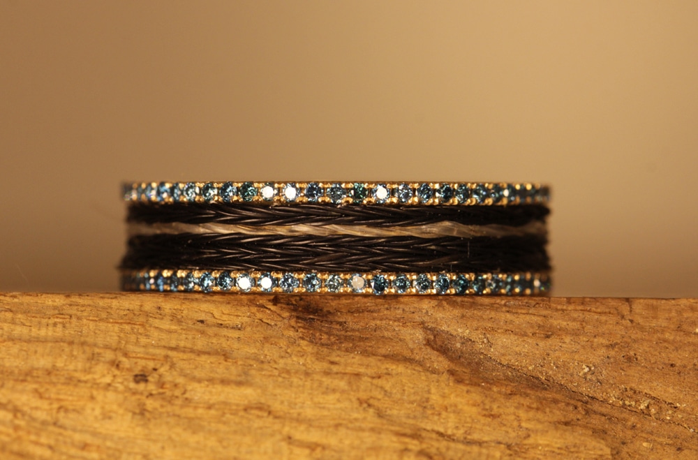 Gold ring with blue diamonds and horse hair