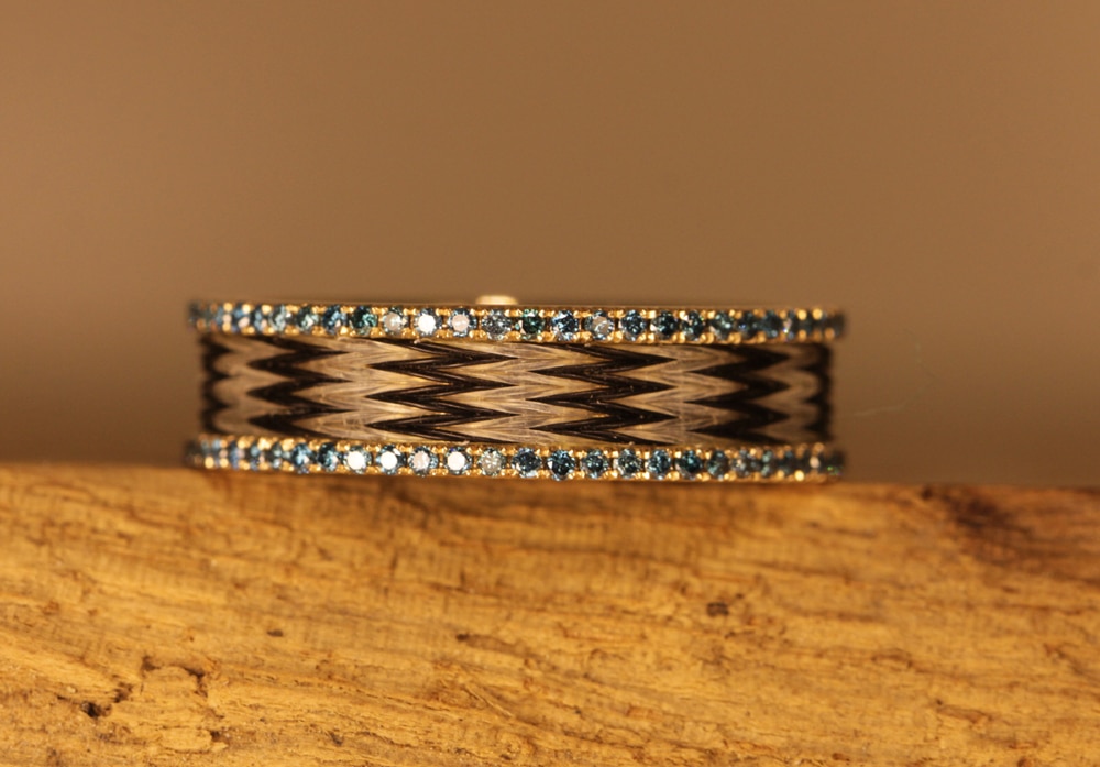Gold ring with woven horse hair and blue diamonds