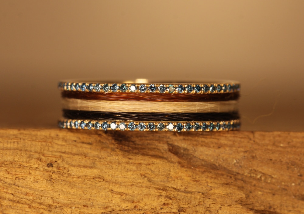 Gold ring with horse hair and blue diamonds