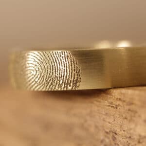 Wedding ring with fingerprint engraving on the outside of the ring
