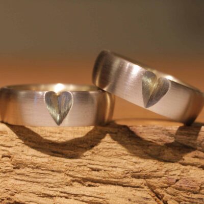 Special two-tone wedding rings outside gray gold inside yellow gold with a heart