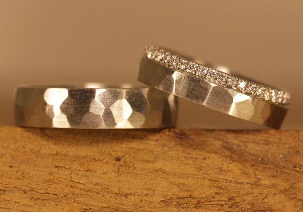 Special wedding rings made of 950 platinum with hammer finish and ladies' ring with diamonds all around