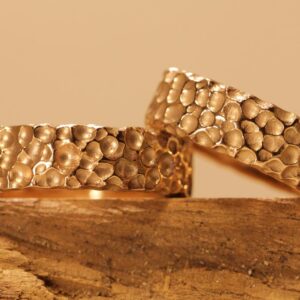 Exceptional wedding rings made of 585 red gold rock-like surface bubbles