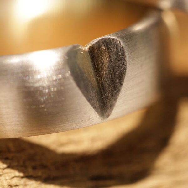 Two-tone wedding rings outside gray gold inside yellow gold with a heart