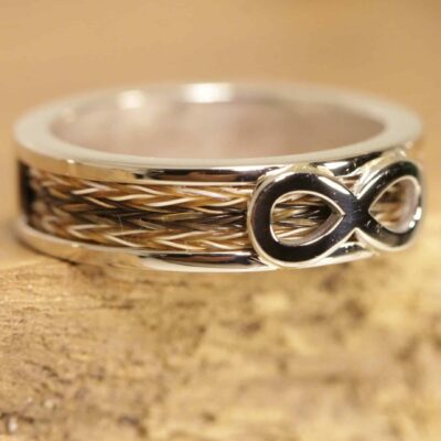 white gold ring with brilliants and woven horsehair and infinity sign