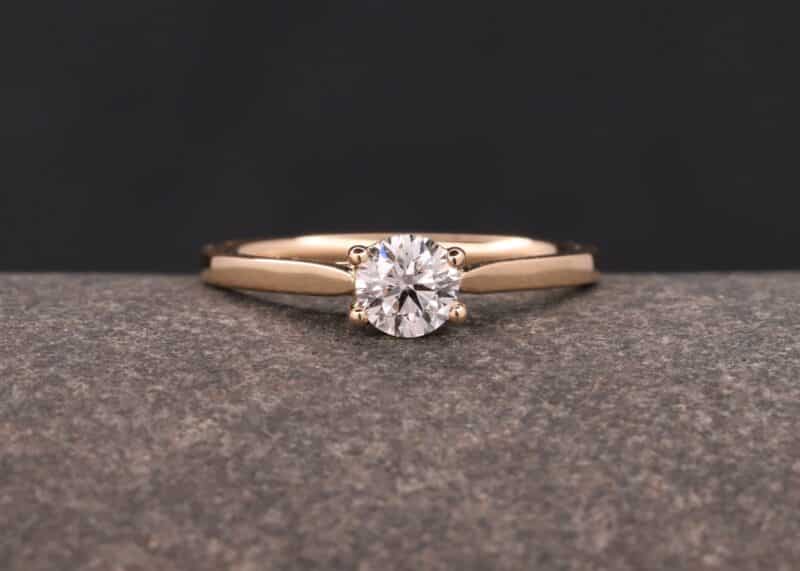 polished rose gold solitaire ring with synthetic diamonds
