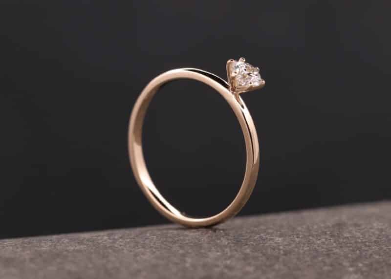 anillo de oro rosa con un brillante en una montura de seis garras